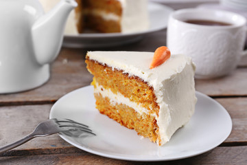 Delicious carrot cake with fork on wooden table