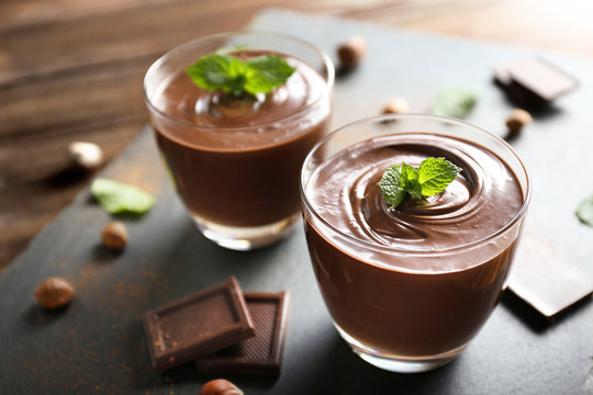 Chocolate mousse with mint in portion glasses on slate cheese board