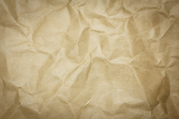 Recycled crumpled brown paper background with copy space for text or image. Dark edged.