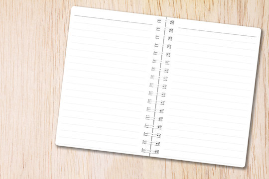 Open notebook paper page with line on natural wood background for design with copy space for text or image.
