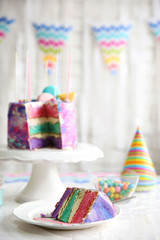 Fototapeta na wymiar Sliced colorful cake on festive table