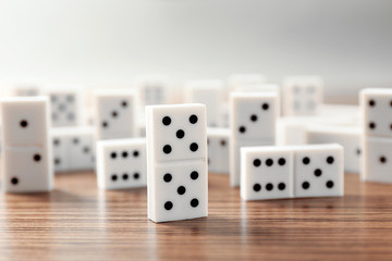 Row of dominoes on wooden table