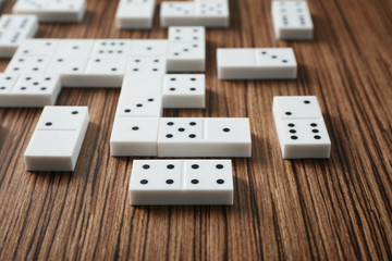 Heap of dominoes on wooden background
