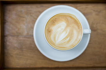 hot latte art on wood table background