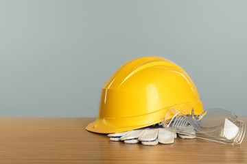 Construction tools and helmet on wooden table