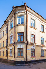 Fototapeta na wymiar Old house in Vyborg, Russia. Building with old fashioned windows and down pipes.