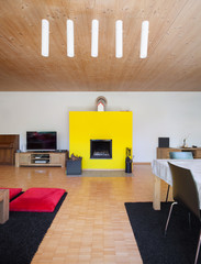 Interior, living room with yellow fireplace