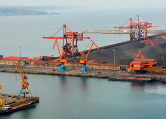 Huge cranes at a port charge