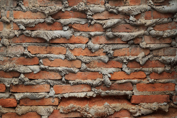The old brick wall with overflow cement at edge joint for backgr