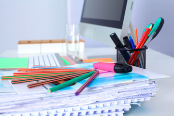 Designer working desk with a computer and paperwork