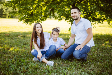 Family of Three Having Fun Together in a Field.Concept of friendly family.