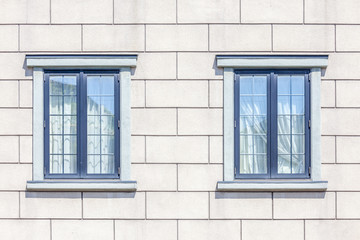 Detail of white brick wall background and two windows decoaratio