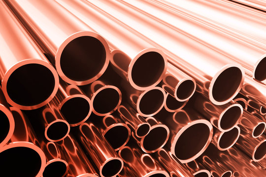 Industry business production and heavy metallurgical industrial products, many shiny steel pipes, industrial background, manufacturing business production concept, copper pipes with selective focus