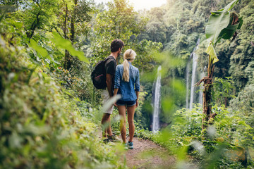 Couple of hikers viewing waterfall