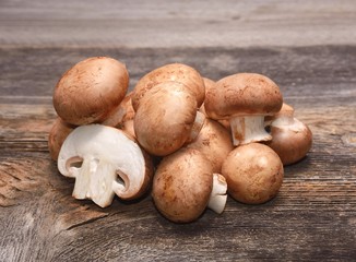 Brown champignon on wooden background