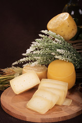 Various cheeses on the wooden board