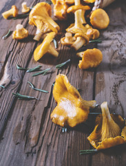 Chanterelles on vintage wooden background top view, healthy food on table mockup, orange mushrooms...