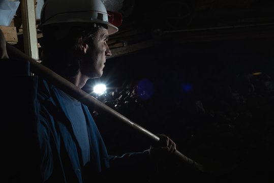 miner shoveling the coal 