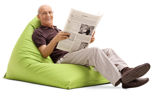 Joyful senior holding a newspaper