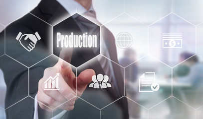 A businessman selecting a Production Concept button on a hexagonal screen