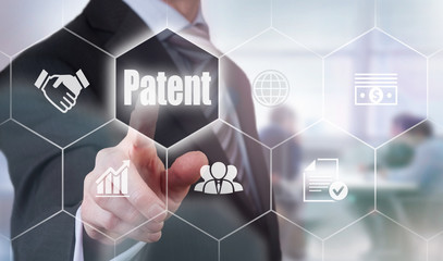 A businessman selecting a Patent Concept button on a hexagonal screen