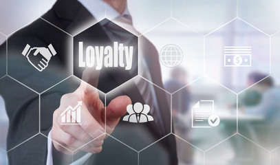 A businessman selecting a Loyalty Concept button on a hexagonal screen
