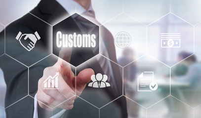 A businessman selecting a Customs Concept button on a hexagonal screen