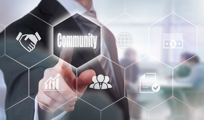 A businessman selecting a Community Concept button on a hexagonal screen