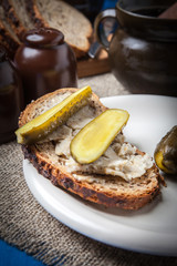 Slice of country bread with homemade lard and cucumber.