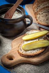 Slice of country bread with homemade lard and cucumber.