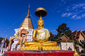 thai golden buddha statue with pagoda