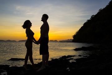 Silhouettes loving couple at sunset on the Philippine Islands