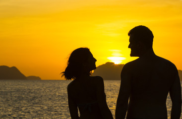 Silhouettes loving couple at sunset on the Philippine Islands