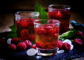 Alcoholic cocktail with strong alcohol, syrup and fresh raspberr