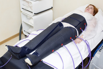 woman at the clinic for the treatment of pressure therapy procedure
