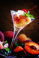 Summer dessert with peaches and whipped cream, decorated with mi