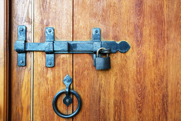 The bolt and lock on a wooden door