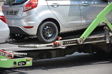 Fototapeta premium New car on the trailer vehicle
