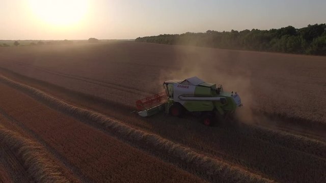 harvester threshing wheat and become dusty.