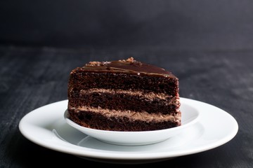 piece of chocolate cake on a dark background