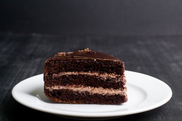 piece of chocolate cake on a dark background