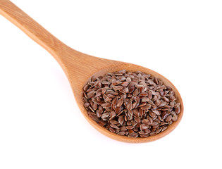 Flax seeds heap in wood spoon isolated on white background