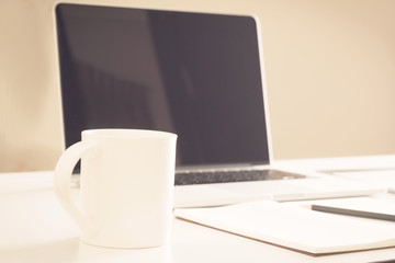 Close-up of comfortable working place with laptop, vintage effec