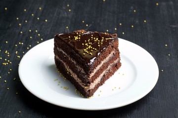 piece of chocolate cake on a dark background