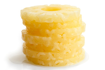 Stack of canned pineapple rings isolated on white.