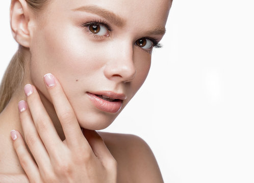 Beautiful young girl with a light natural make-up and French manicure. Beauty face.