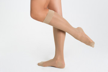 Female legs in socks on white background