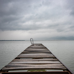 Obraz premium Old wooden dock in summer stormy weather