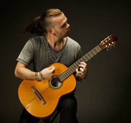 The guy playing an acoustic guitar.