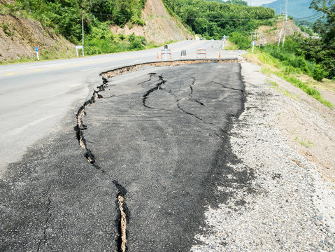 asphalt road cracked and broken texture